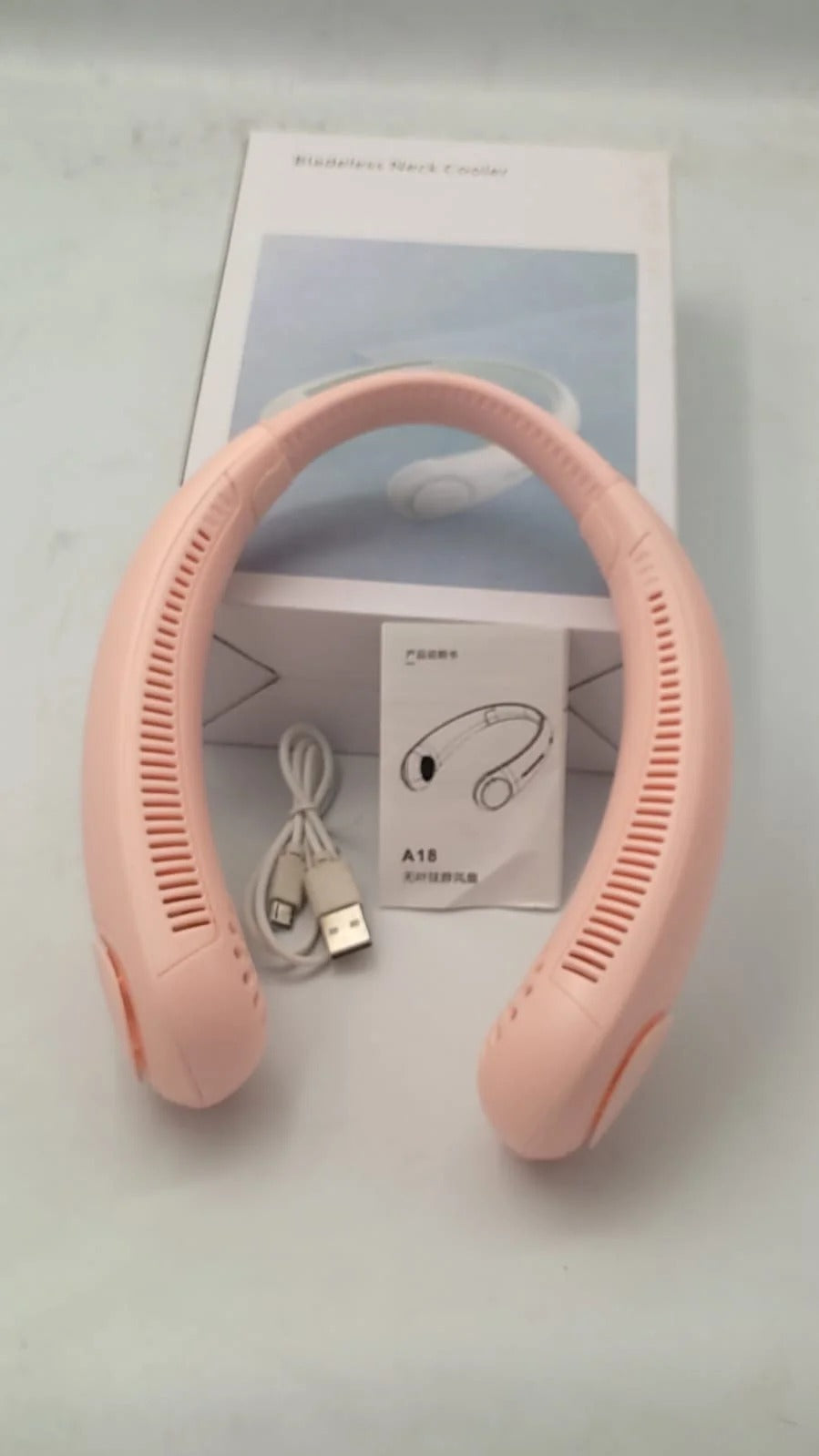 Portable vaneless neck hanging fan with USB rechargeable battery and hands-free 360-degree cooling.
